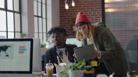 young business people working in startup office caucasian team leader woman pointing at tablet computer screen showing colleague creative ideas training intern brainstorming discussing information