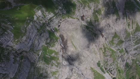 Aerial-view-of-stunning-waterfall-and-dramatic-cliffs-in-the-French-Alps