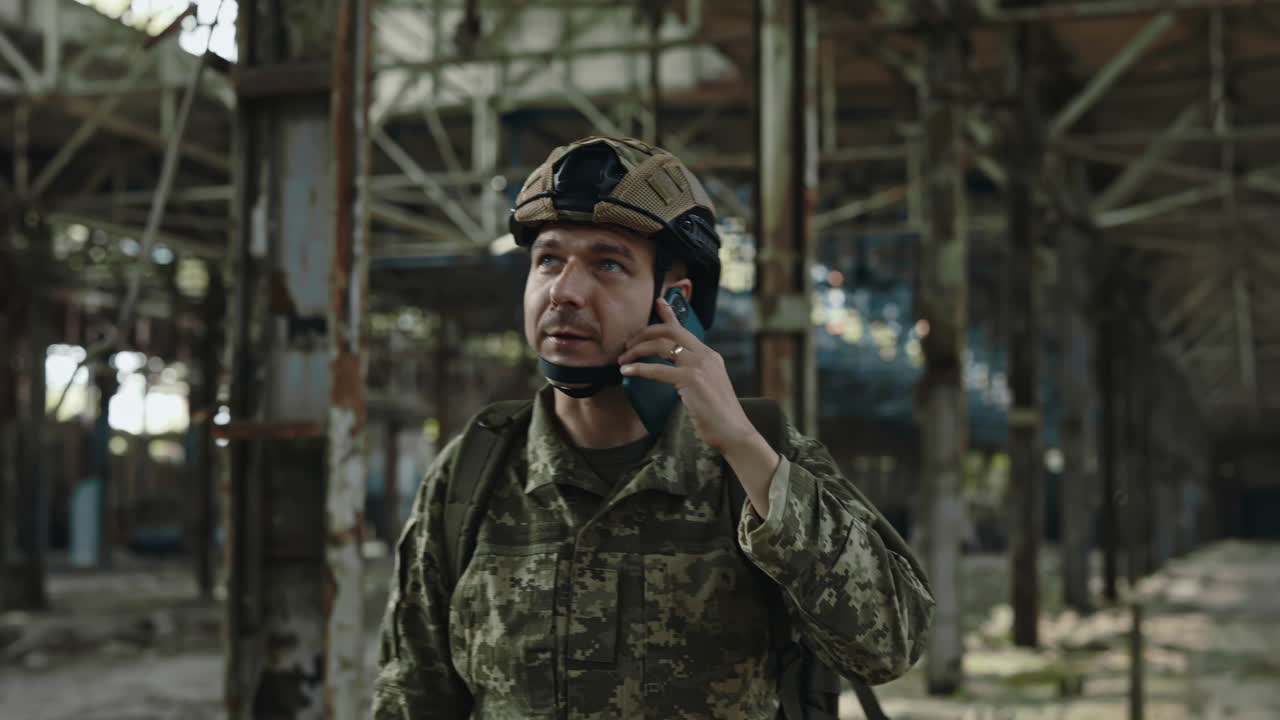 Soldier Talking on Phone in a Ruined Factory