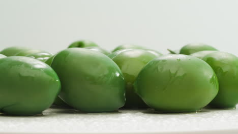 aceitunas verdes redondas en vinagre de grecia como fondo, vista de arriba. imágenes de alta calidad en 4k