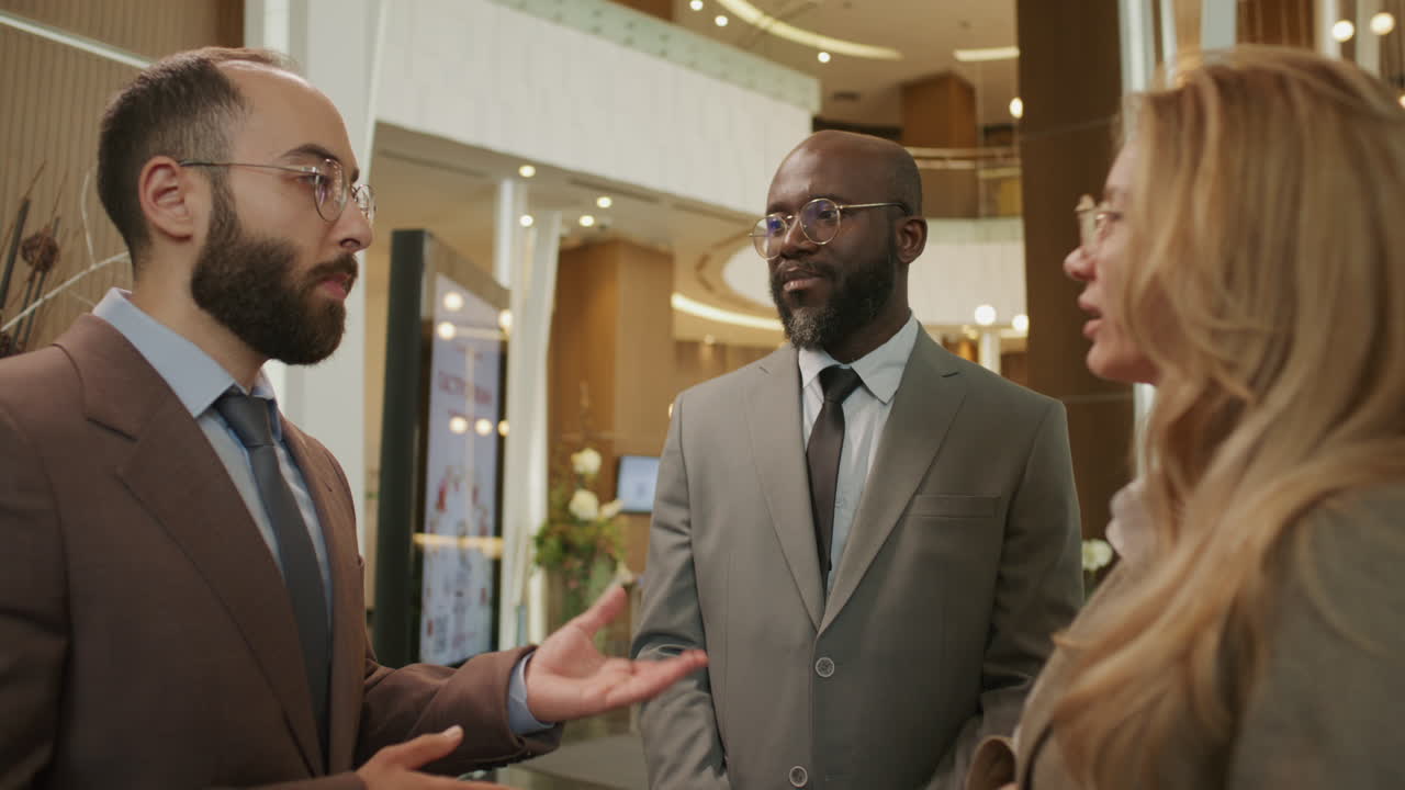 Team of Diverse Business Professionals Talking in High-End Hotel Lobby