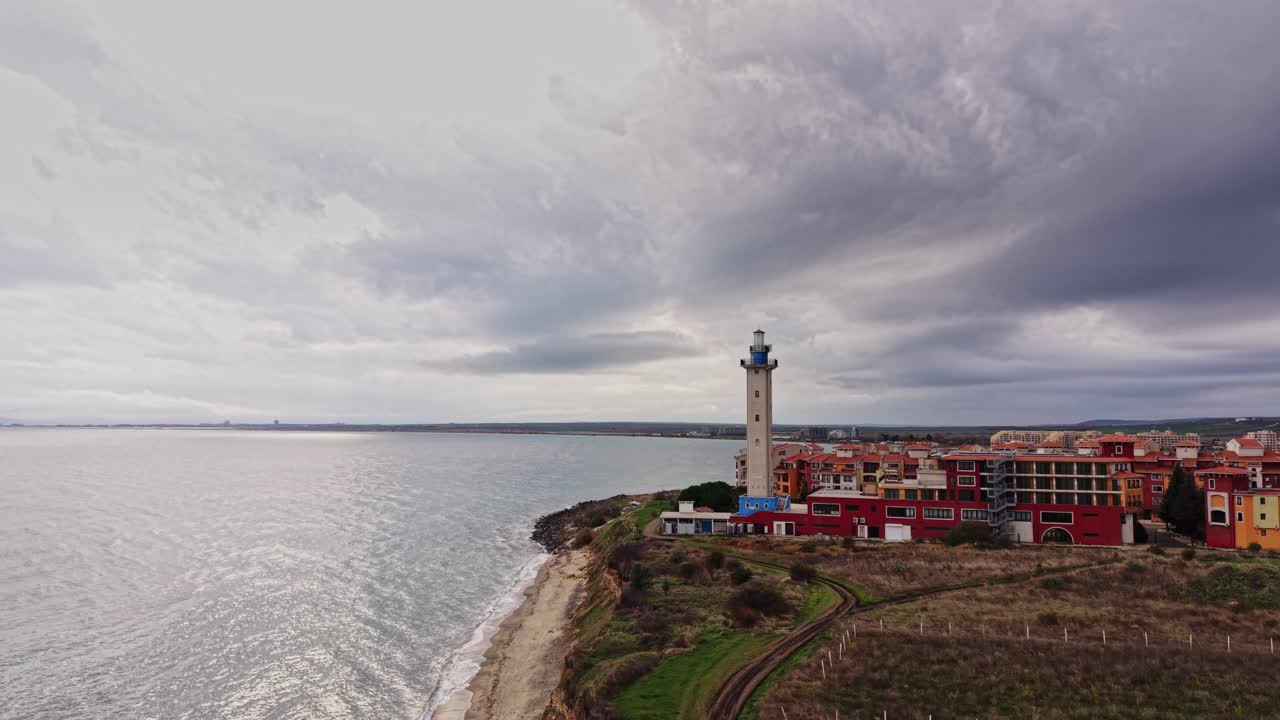 Dramatic aerial view of a lighthouse and coastal buildings in Bulgaria