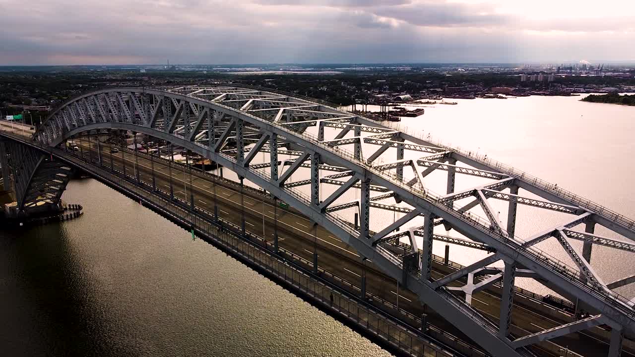 Close-up footage of people and cars crossing the bayonne bridge near New York City - decending pan aerial footage