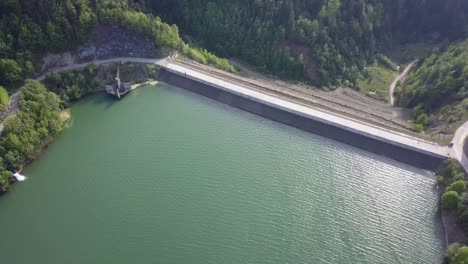 Aeiral-Panning-shot-of-Road-dividing-water-and-land-where-the-reservoir-is