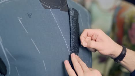 the tailor kills the collar of his jacket for tailoring