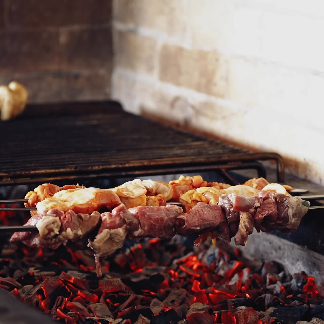 Cooking delicious meat on charcoal. Meat on skewers. Marinated shashlik preparing on a barbecue grill. Appetizing meat grilled on skewers.