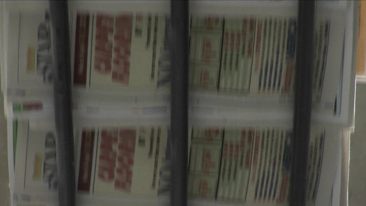 Newspapers flow along an assembly line in a newspaper factory 5