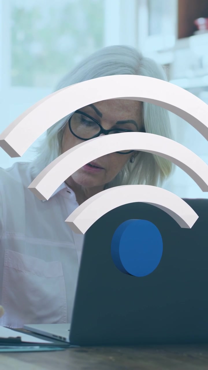 Vertical video: Woman leaning to laptop after 3D Wi?Fi overlay appearing checking docs for network