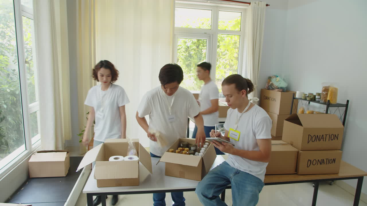 Students Packing Boxes with Necessities for Refugees in Donation Center