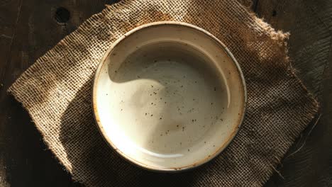 rustic empty bowl on burlap placemat