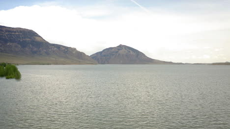 vast lake with mountains and cloudy sky