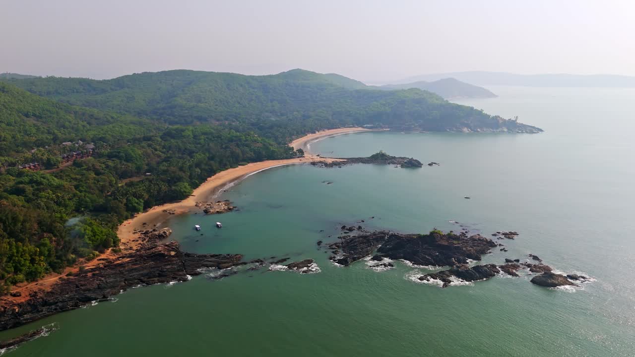 Aerial view overlooking the Om beach, sunny morning with haze in Gokarna, India