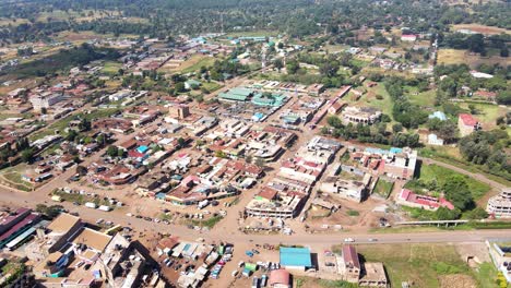 Aerial-view-of-cars-and-people-at-a-Open-Air-Market,-in-Africa---reverse,-drone-shot