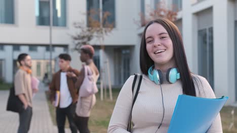 Happy female student smiling to the camera