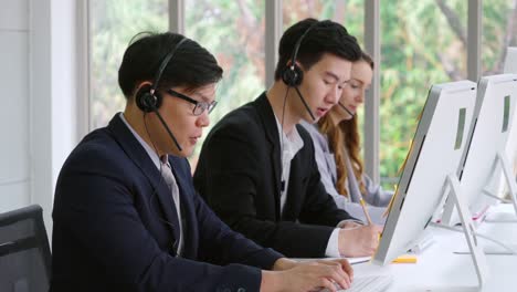 Business-people-wearing-headset-working-in-office