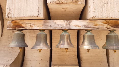 Five-old-bells-on-a-wooden-beam