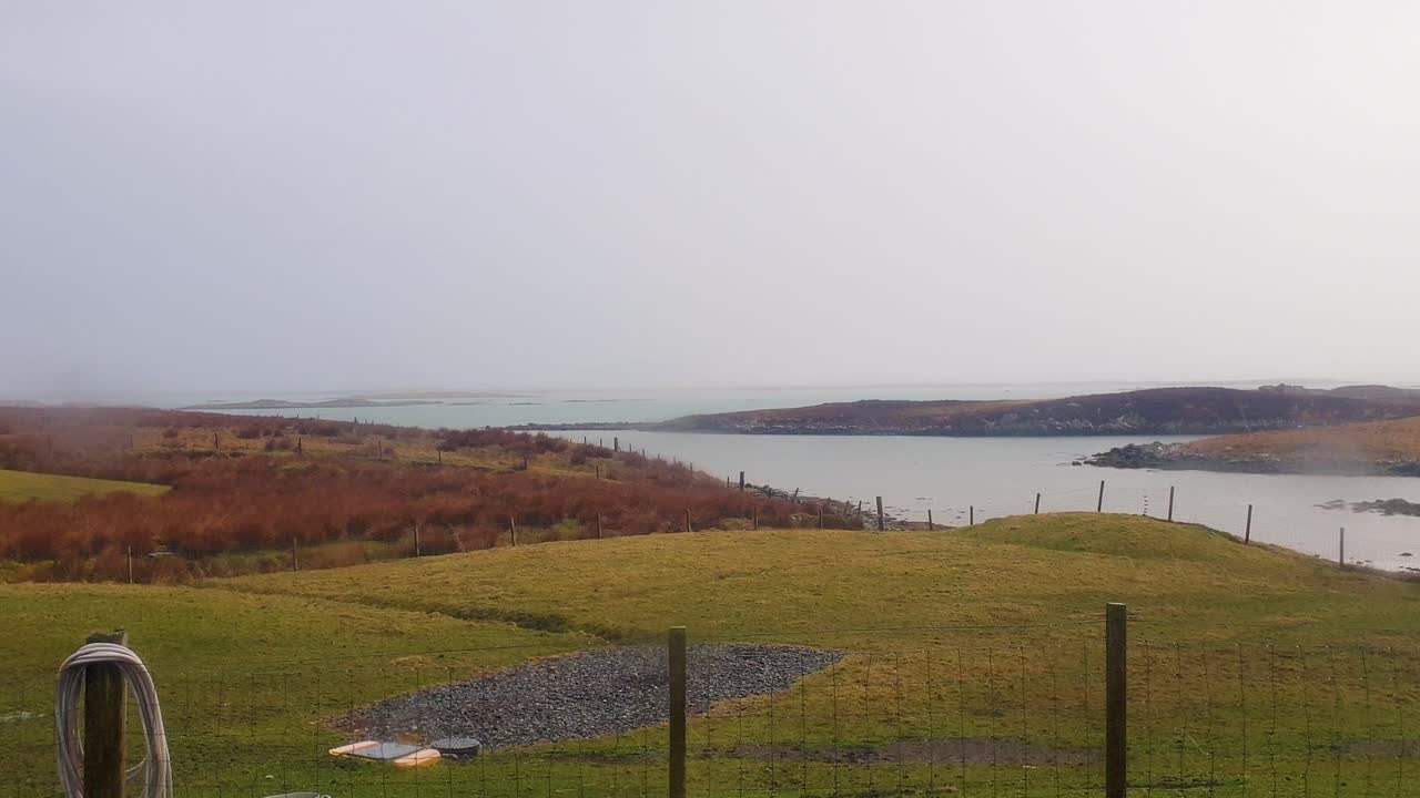 Misty Coastal Landscape with Fields and Bay
