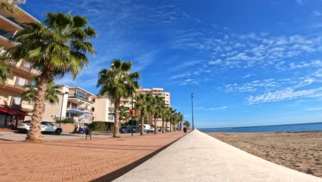 Coastal-sidewalk-and-bike-path-traveled-lightly-on-a-sunny-day-by-tourist