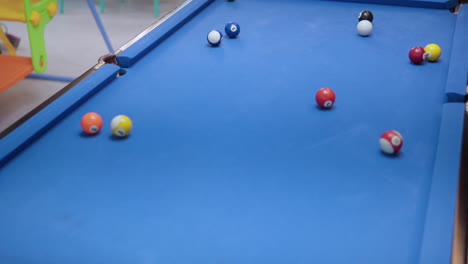 pool, pocket billiards complicated scoring - woman hits cue ball, it bounces and sinks goes down a pocket hole