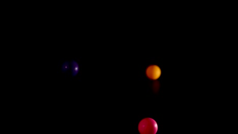 vibrant balls bouncing against a dark background