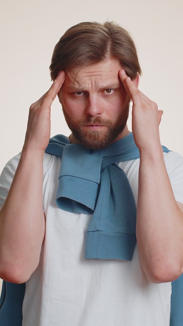 Sick ill man rubbing temples to cure headache problem suffering from tension migaine stress pain