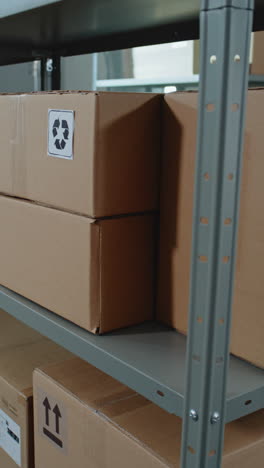 warehouse storage with cardboard boxes and recycling symbols