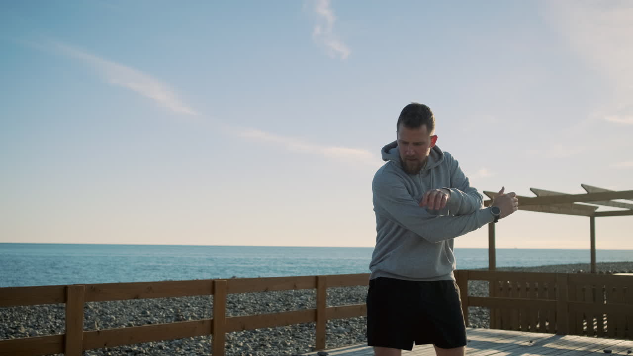 Man Jumping Rope and Stretching on a Beach Pier