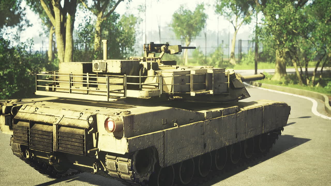 Military tank on a sunny day near a forest path with clear blue skies