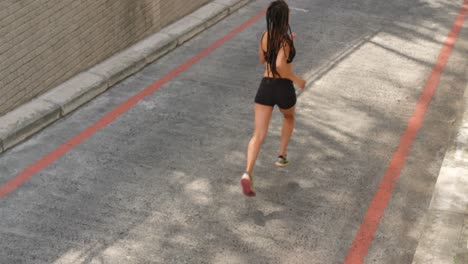 High-angle-view-of-African-American-woman-jogging-in-the-city-4k