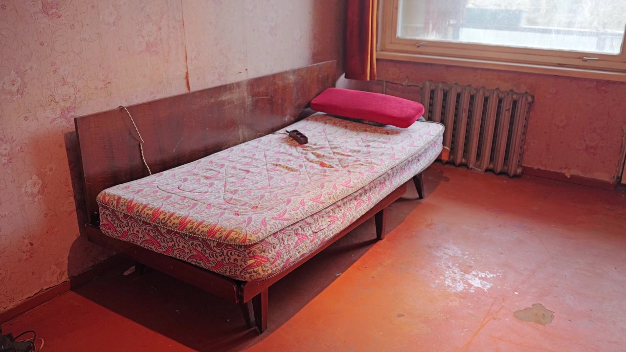 Forgotten bedroom preserves authentic vintage furniture and nostalgic home atmosphere.