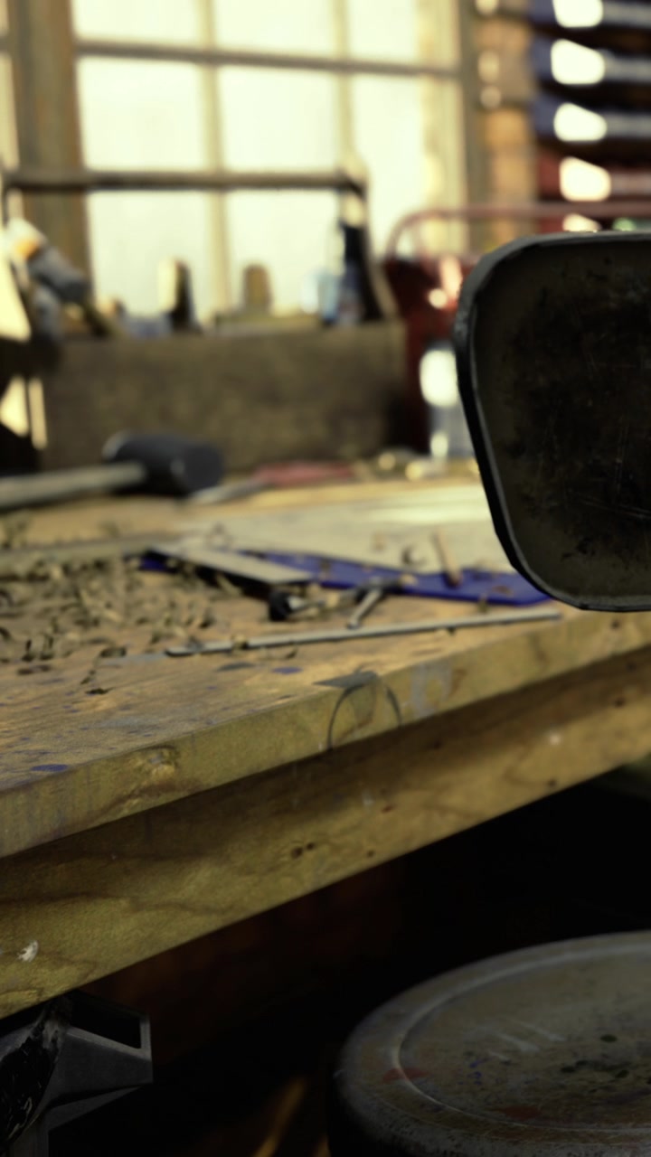 Workshop scene filled with tools and a wooden workbench in warm lighting