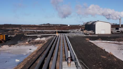 Geothermal-pipeline-at-renewable-energy-power-plant-in-Iceland,-aerial