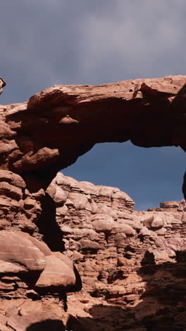 a natural arch in a red rock canyon