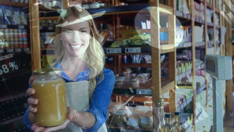 animation of data processing over happy caucasian female shopkeeper holding jar of honey in shop