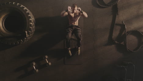 man doing sit-ups in a gym