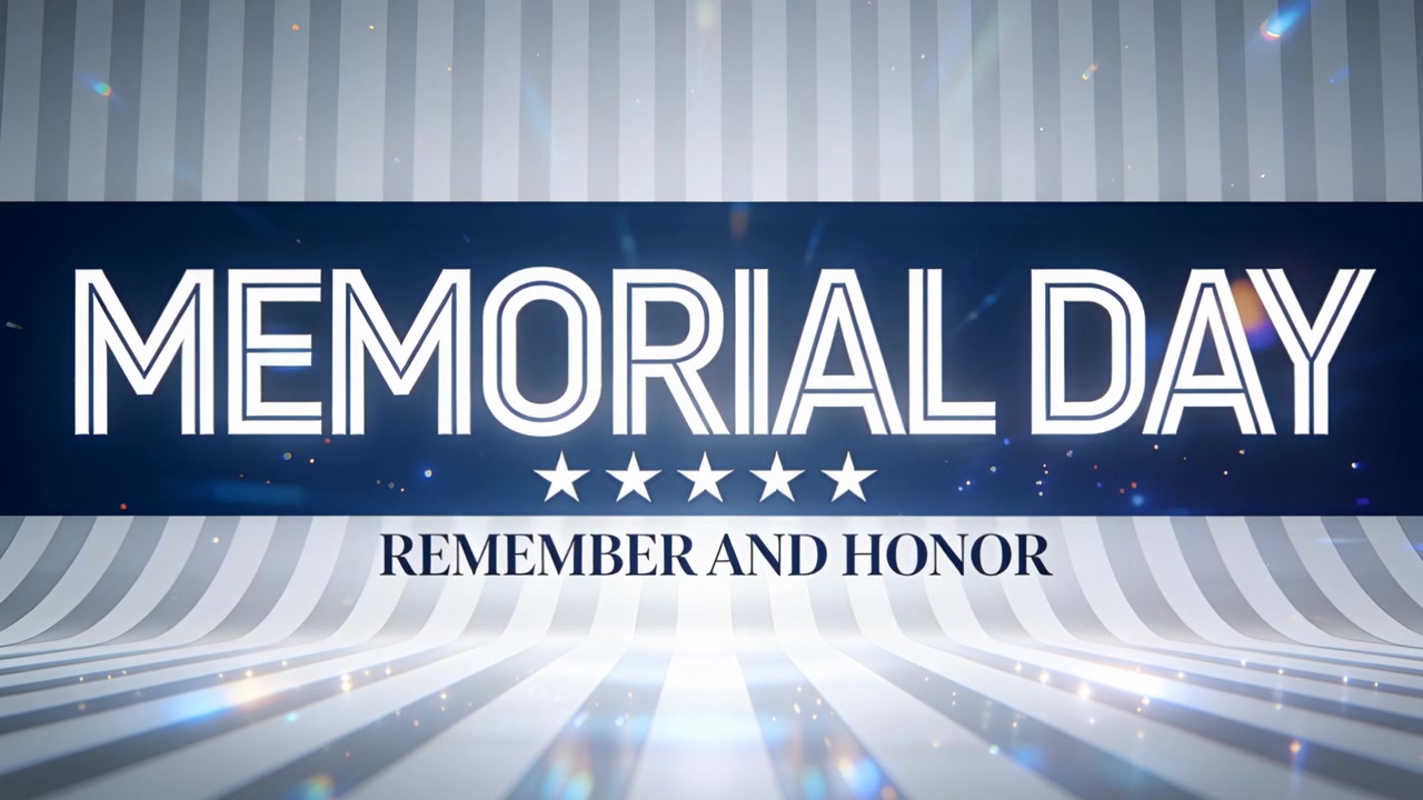 Avvio riproduzione: banner "MEMORIAL DAY" con luce pulsante e bagliori blu su un set da studio, messaggio commemorativo.