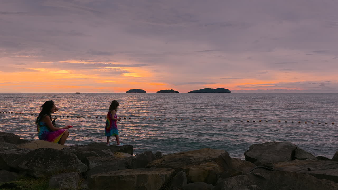 Korean Mother with Little Mixed Girl at Rocky Sunset Island Beach in Kota Kinabalu - wide