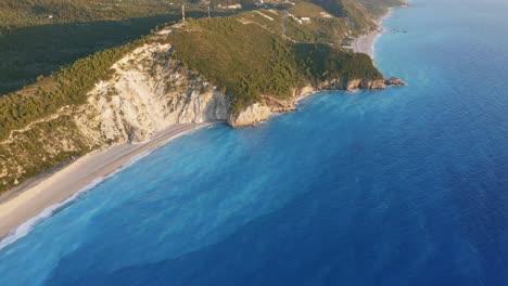 aerial view of beautiful milos beach and coastline of lefkada, ionian island, greece. sunset golden sunlight and turquoise blue sea