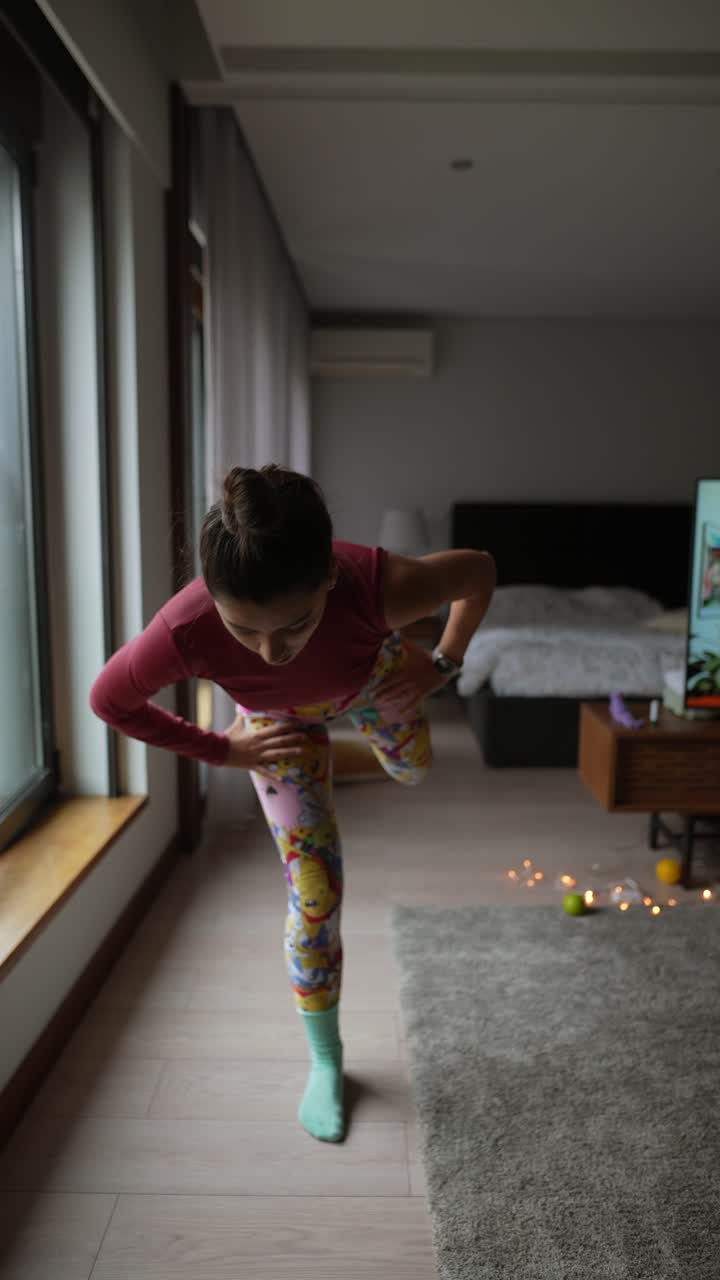 Woman practicing yoga at home