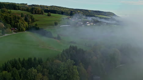 Aerial-view-of-the-mountainous-area-with-mist-shrouded-forests-around-the-Austrian-Attersee