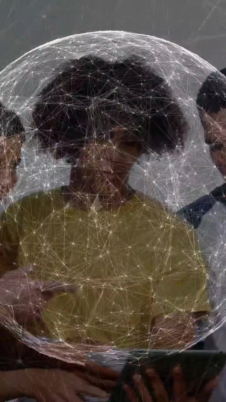 Vertical video: Lead tapping tablet causing team pointing and using app with tech overlay on lead