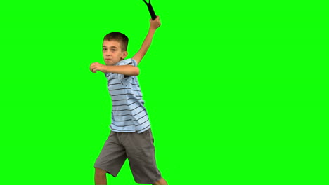 Little-boy-playing-tennis-on-green-screen