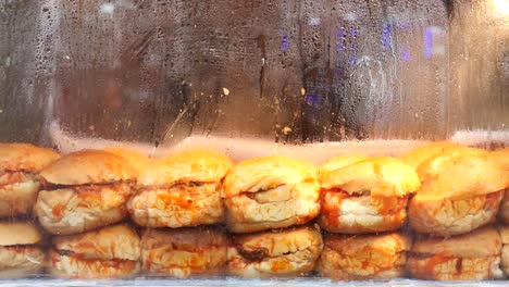 close up of sandwiches with tomato sauce in a display case