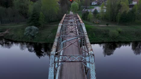 cinematic drone view of old pedestrian bridge in valmiera, latvia
