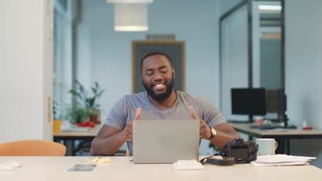 Happy-professional-correcting-photos.-Closeup-black-man-satisfied-of-project.