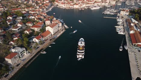 drone follow shot of cruise ship coming back to port of mila, brac island, croatia