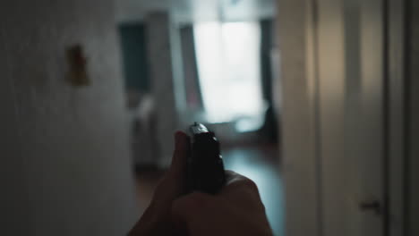 first-person pov of a person drawing a handgun from a holster, cautiously moving and aiming through an indoor space, with a focus on home defense