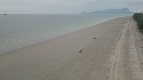 drone view driving at the white sandy terombol beach,kuching,sarawak