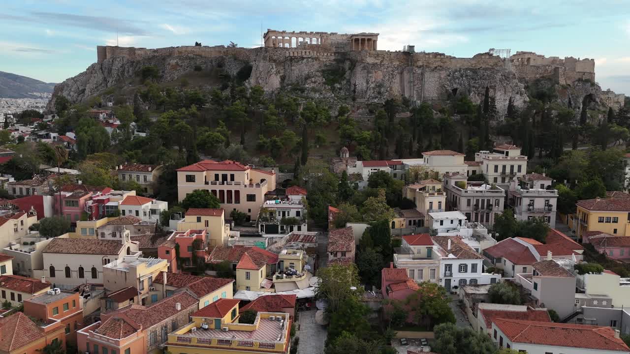 Athens,Aerial view ascending and forward towards Acropolis, approaching slowly towards Erechtheion and Parthenon before the sunset. Beautiful Blue-pink sky with white clouds