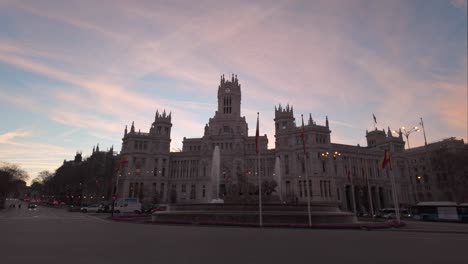 establishing shot sunrise madrid city town hall casa de correos and cibeles square and fountain with colorful beautiful clouds